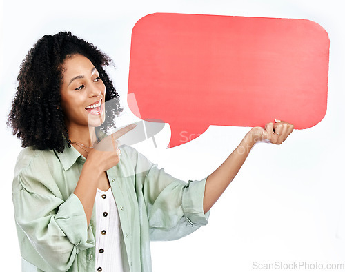 Image of Woman, smile and hand pointing to speech bubble in studio for social media, contact or info on white background. Happy, lady and show poster for voice, feedback or FAQ, forum or conversation quote