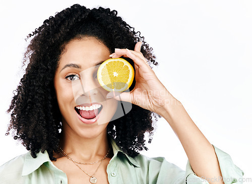 Image of Vitamin c, lemon and eye or portrait of woman with fashion for organic wellness isolated in a studio white background. Diet, fruit and happy or excited young person with crazy citrus energy and detox