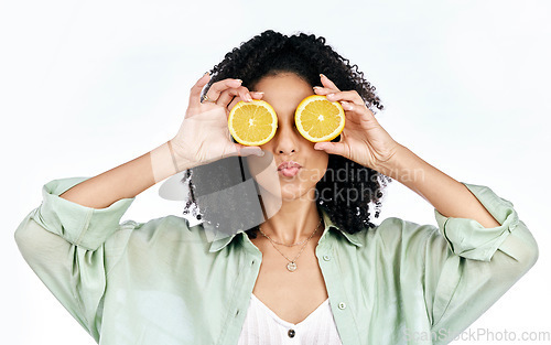 Image of Vitamin c, lemon and eye of woman with a pout for organic wellness or fashion isolated in a studio white background. Diet, fruit and happy or excited young person with crazy citrus energy and detox