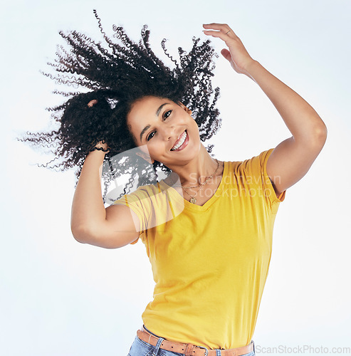 Image of Hair, dancing and portrait of a woman with afro hairstyle, smile and fashion isolated in a studio white background. Smile, casual and young person with stylish or trendy clothes happy for freedom
