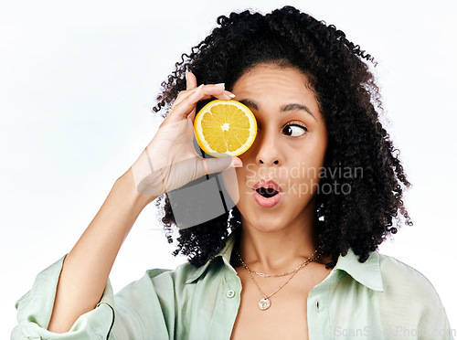 Image of Vitamin c, lemon and eye of shocked woman with fashion for organic wellness isolated in a studio white background. Diet, fruit and healthy or excited young person with crazy citrus energy and detox