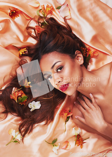 Image of Fashion, silk and flowers by a woman with beauty and cosmetic glamour fabric for wellness, glow and skincare. Aesthetic, plants and portrait young female person with luxury elegant backdrop in spring
