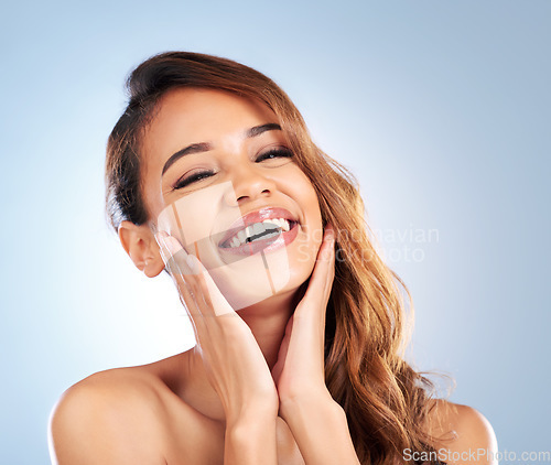 Image of Laughing, skincare or happy woman in portrait for beauty, wellness or anti aging in studio on blue background. Natural facial routine, funny girl or face of model with smile or healthy glowing skin