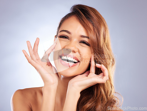 Image of Dermatology, skincare and portrait of woman with natural beauty, anti aging care and wellness from cosmetics on studio background. Laughing, face and hands touching healthy and clean skin texture