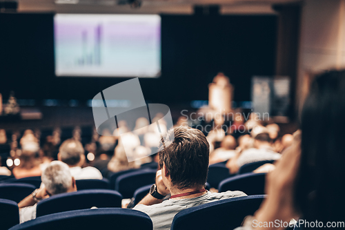 Image of Speaker giving a talk on scientific conference. Audience at the conference hall. Business and Entrepreneurship concept.