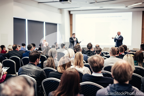 Image of I have a question. Group of business people sitting in conference hall. Businessman raising his arm. Conference and Presentation. Business and Entrepreneurship