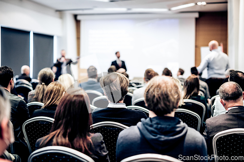 Image of I have a question. Group of business people sitting in conference hall. Businessman raising his arm. Conference and Presentation. Business and Entrepreneurship