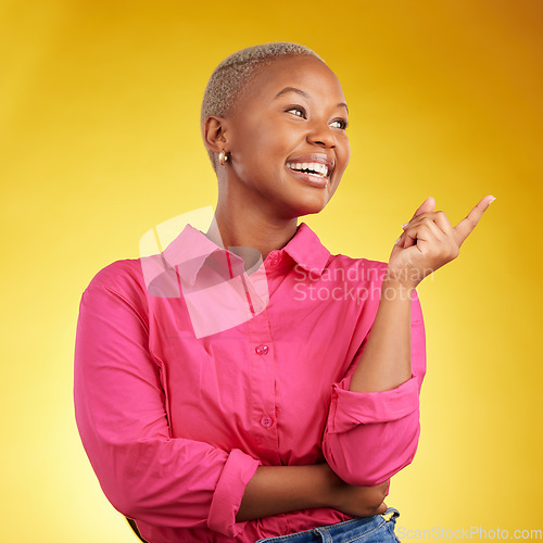 Image of Smile, black woman and hand pointing in studio for news, deal or coming soon announcement on yellow background. Finger, show and happy African female show list, promo or sign up contact information