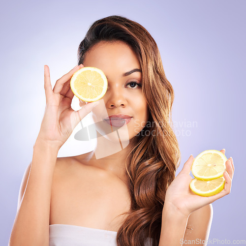 Image of Vitamin c, lemon and eye of woman with healthy, natural or organic beauty isolated in a brown studio background. Excited, happy and portrait of young female person with citrus for skincare or detox