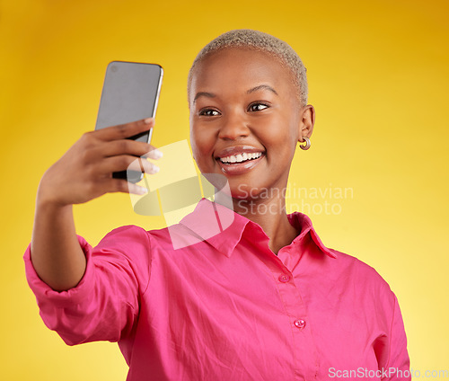 Image of Smile, selfie and happy black woman in studio isolated on a yellow background. Profile picture, photographer and African person or influencer taking photo for memory, social media or blog on internet