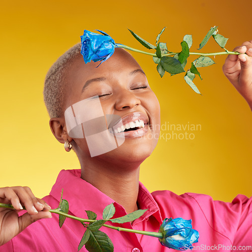 Image of Happy, smile and spring with black woman and rose in studio for blossom, plant and environment. Gift, love and blue flower with face of person on yellow background for floral, scent and mockup