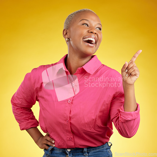 Image of Happy, black woman and hand pointing in studio for news, deal or coming soon announcement on yellow background. Finger, smile and excited African female show list, promo or sign up contact info