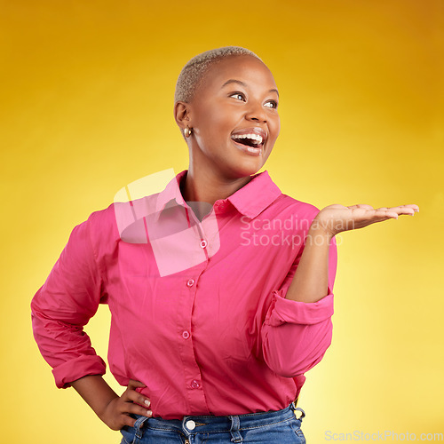 Image of Hand, smile and black woman in studio with sale, news or promotion on yellow background. Happy, deal and African lady show competition, giveaway or contact, info and sign up, platform or how to steps