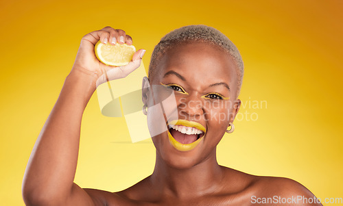 Image of Happy black woman, portrait and lemon for vitamin C or natural beauty against a yellow studio background. African female person with organic citrus fruit for diet detox, facial cosmetics and makeup