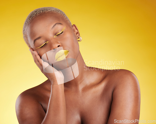 Image of Creative, makeup and face with lipstick or black woman in studio on a yellow background for art, beauty or cosmetics. Gold, color and eyeshadow on calm model sleeping with unique aesthetic or art