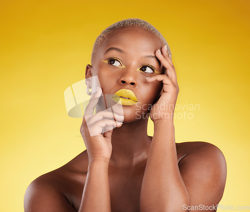 Image of Thinking, makeup and a black woman on a studio background for art or fashion. Ideas, gold and an African girl or model with yellow lipstick, cosmetics or young beauty on a backdrop for creativity