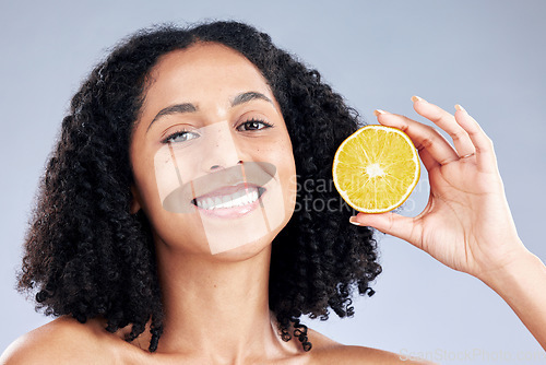 Image of Woman, lemon and skincare in studio portrait with smile, health and nutrition for wellness by background. Girl, African model and fruit for face, cleaning or cosmetics for beauty, self care or change