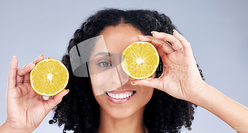 Image of Portrait, skincare and woman with lemon eye for wellness or nutrition in grey studio background. Happy face, girl and vitamin c for dermatology with smile, fruit, diet or natural facial treatment.