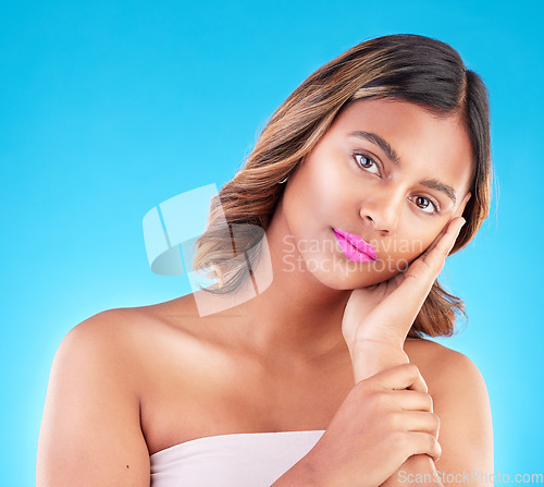 Image of Portrait, woman and beauty, pink lipstick and makeup with skincare isolated on blue background. Facial, wellness and cosmetic product for lips, cosmetology and female model with skin glow in studio