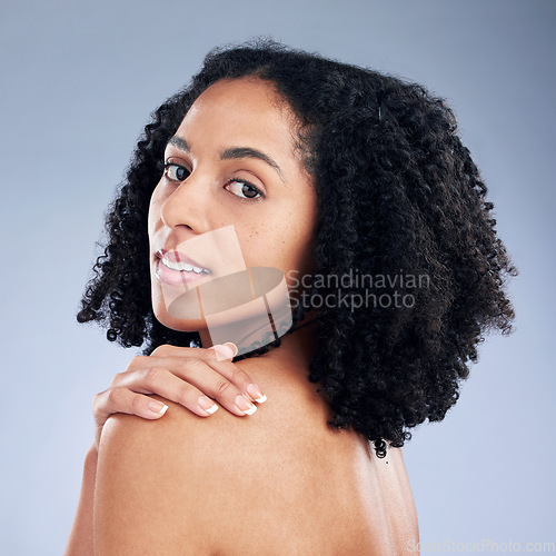 Image of Skin care, beauty and portrait of a woman with hand on shoulder for dermatology and cosmetics. Face of a young African female model on a studio background for self love, natural glow and soft touch