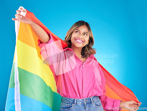 Image of Lgbtq flag, freedom and woman with support, pride and transgender right on a blue studio background. Female person, lesbian or model with symbol for queer community, equality or celebration with hope