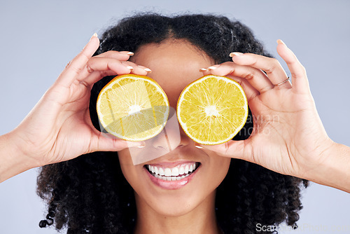 Image of Woman, lemon eyes and skincare in studio for comic smile, health or nutrition for wellness by background. Girl, African model and fruits for diet, cleaning and cosmetic for beauty, self care or emoji