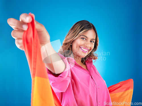 Image of LGBTQ woman, flag and studio portrait with beauty, peace and freedom with pride for inclusion by blue background. Lesbian girl, student or model with smile for protest, icon or advocate for sexuality
