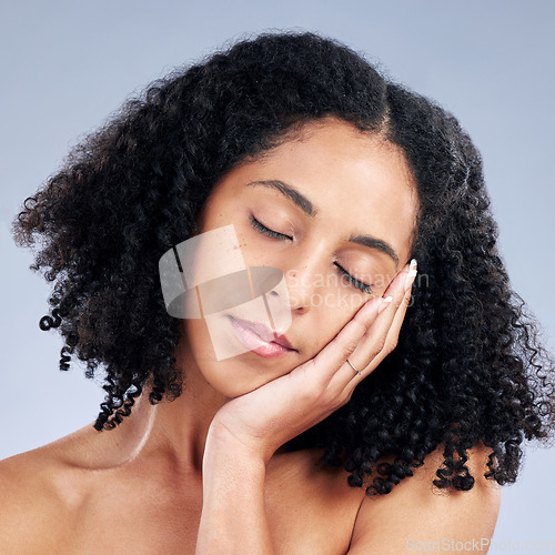 Image of Woman touching face, beauty and natural skincare, cosmetics and curly hair on studio background. Haircare, wellness and self care, healthy skin glow and peace with female model and dermatology