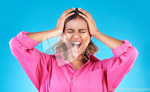 Image of Angry, frustrated and a shouting woman on a blue background with a anger about mental health. Stress, bipolar and a young screaming Indian girl with a fail or mistake isolated on a studio backdrop