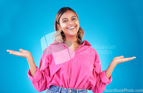 Image of Space, choice and presentation with portrait of woman in studio for decision, show and information. Offer, advertising and deal with face of person on blue background for thinking, option and mockup