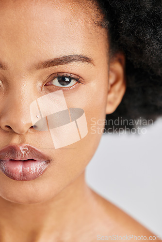 Image of Beauty, studio portrait and African woman with skincare shine, foundation makeup and natural cosmetics for skin glow. Closeup half face, eye and person with self care wellness on white background