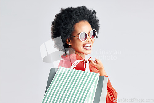 Image of Happy black woman, afro and shopping bags for discount, sale or fashion deal against a white studio background. Portrait of African female person, customer or shopper smile for purchase in happiness