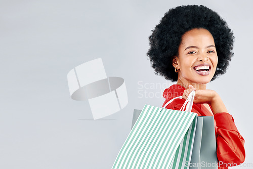 Image of Shopping bag, portrait and young woman for fashion discount, sale and retail promotion on a white background. Gift, giveaway and happy customer, model or african person with mockup space in studio