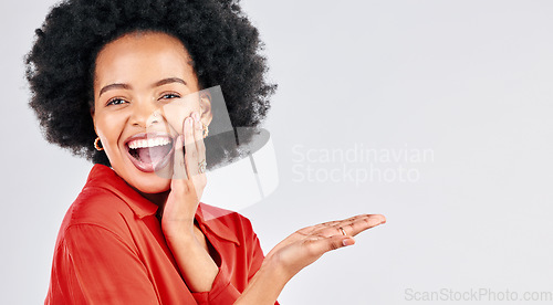 Image of Happy black woman, portrait and afro with palm for advertising against a white studio background. Excited African female person in wow for showing advertisement, branding or marketing on mockup space