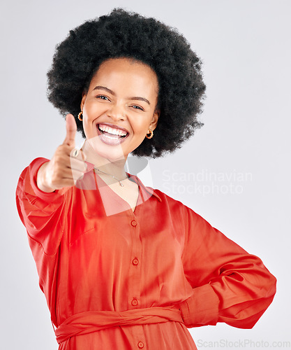 Image of Thumbs up, smile and portrait of a businesswoman in studio with success, achievement or goal. Happiness, smile and professional African female person with an approval hand gesture by gray background.