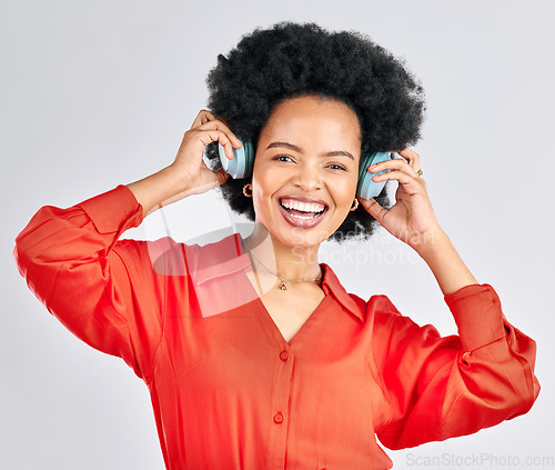 Image of Portrait, black woman and music headphones in studio for podcast, audio and subscription on white background. Face of happy female model listening to album, streaming sound and hearing song on radio