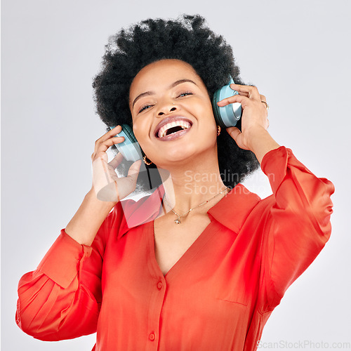 Image of Music, headphones or happy black woman listening to radio playlist to relax on white background in studio. Hearing, freedom or African person dancing, smiling or streaming a song audio or sound track