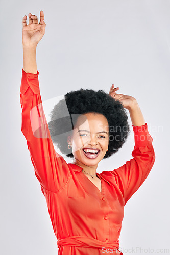 Image of Happy black woman, portrait and dancing with afro in stylish fashion against a white studio background. Excited African female person in celebration for winning, achievement or bonus promotion