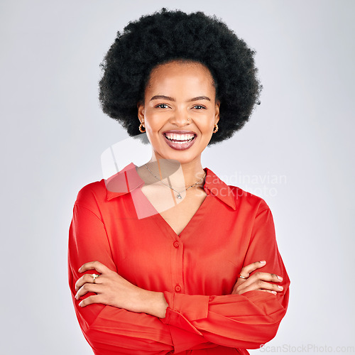 Image of Happy black woman, portrait and afro with arms crossed in fashion against a white studio background. African female person smile in confidence for career ambition, pride or proud with clothing style