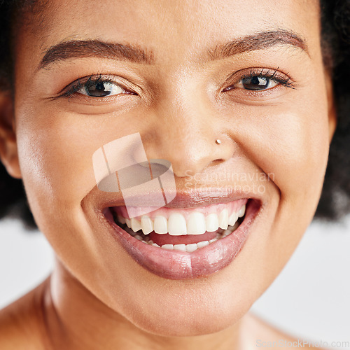 Image of Portrait, skin care and beauty of a black woman with dermatology, cosmetics or natural makeup. Closeup and face of happy African female model in studio for facial glow, self love and teeth smile