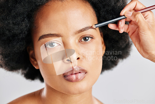 Image of Portrait, african woman and beauty with eyebrows in grey studio background for facial. Portrait, beauty and face with girl drawing brow with makeup for transformation for cosmetology or self care.