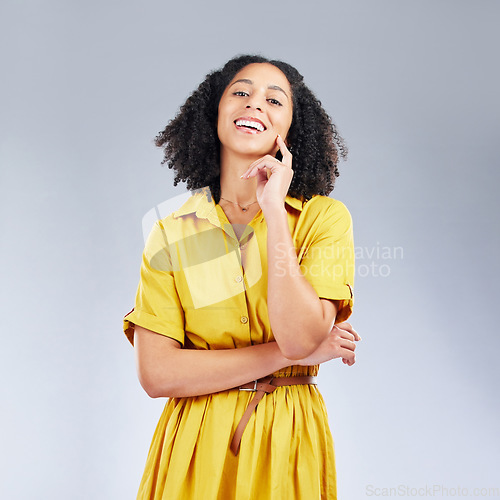 Image of Portrait, fashion and happy with a model woman in studio on a white background for trendy style. Yellow, smile and beauty with a confident young female person with an afro posing in a clothes outfit