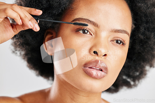 Image of Skincare, cosmetics and eyebrow brush for beauty with african girl in grey studio or background. Makeup, brow and woman with facial cosmetology for dermatology or glow for elegant natural face.