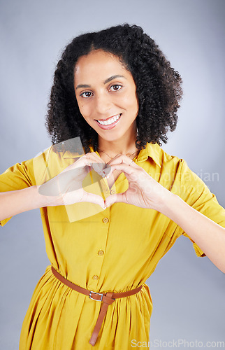 Image of Heart, sign and happy woman for fashion portrait with thank you, support and hands emoji on a white background. Face, trendy clothes and young african person or model with self care or love in studio