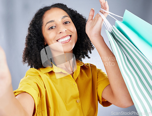 Image of Shopping bag, selfie and woman in portrait for discount, sale and happy on white background. Retail, face and fashion influencer, african person or customer with profile picture photography in studio