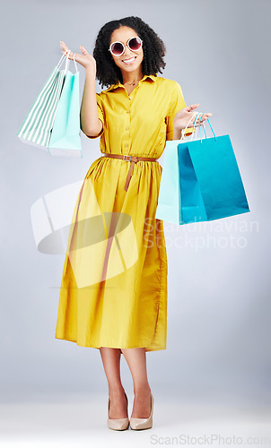 Image of Happy woman, portrait and shopping bags for fashion or style against a white studio background. Excited female person, customer or shopper smile for discount, sale or purchase in promotion with gifts