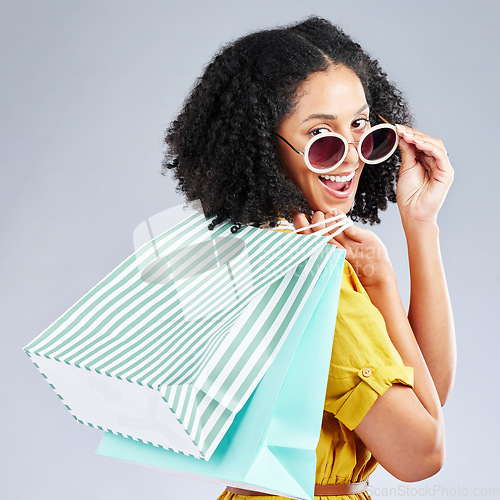 Image of Shopping, bag and portrait of woman excited for retail sale, promotion or discount on studio, mockup or grey background. Wow, customer and girl to shop for fashion or sales on luxury clothing