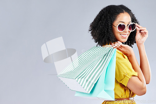 Image of Shopping, bag and woman happy for retail sale, promotion or excited for discount on studio, mockup or grey background. Customer, portrait or girl to shop for fashion or sales on luxury clothing