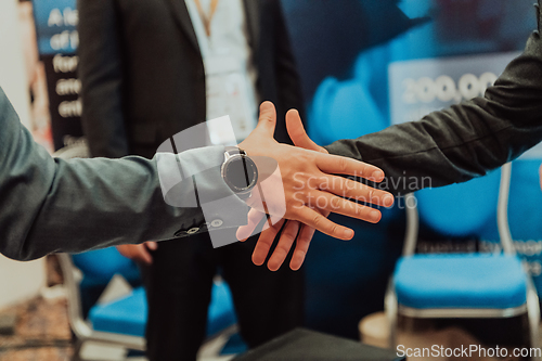 Image of Close up a handshake, businessman together creates a mutually beneficial business relationship. The economic graph on the table