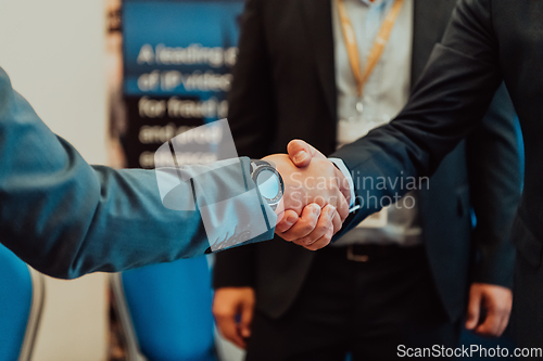 Image of Close up a handshake, businessman together creates a mutually beneficial business relationship. The economic graph on the table